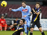 Napoli's Gonzalo Higuain fights for the ball with Parma's Jonathan Biabiany and Felipe during the Serie A football on November 23, 2013