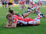 Billy Twelvetrees of Gloucester Rugby dives over to score a try despite the efforts of Luke Wallace of Harlequins during the Aviva Premiership Rugby match between Harlequins and Gloucester at Twickenham Stoop on November 23, 2013