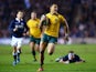 Israel Folau of Australia breaks free from Moray Low and the Scottish defence to scores a try during a game on November 23, 2013