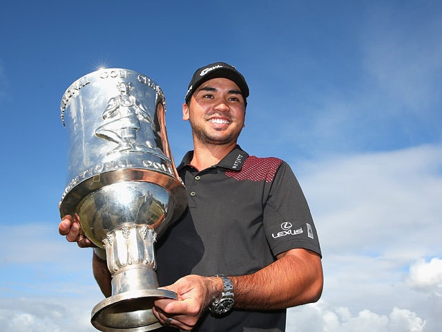 Jason Day poses with the trophy after winning the tournament in the final round of the World Cup of Golf on November 24, 2013