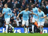 Man City's Jesus Navas celebrates with teammates after scoring the opening goal against Tottenham on November 24, 2013
