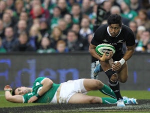 New Zealand's Julian Savea evades a tackle from Ireland's Conor Murray to score a try during their international match on November 24, 2013