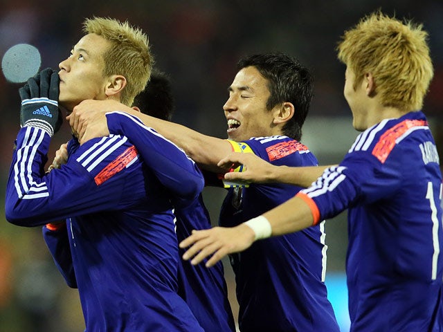 Japan's Keisuke Honda celebrates after scoring his team's second goal against Belgium during their international friendly match on November 19, 2013