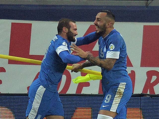 Greece's Konstantinos Mitroglou celebrates after scoring the opening goal against Romania during their World Cup play-off match on November 19, 2013