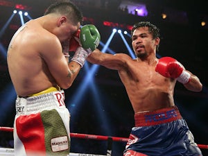 Manny Pacquiao in action against Brandon Rios during their WBO International Welterweight title bout on November 24, 2013