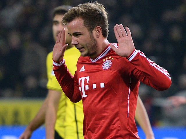 Bayern Munich's midfielder Mario Goetze refuses to celebrate after scoring the 0-1 during the German first division Bundesliga football match against his old club Borussia Dortmund on November 23, 2013