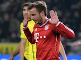 Bayern Munich's midfielder Mario Goetze refuses to celebrate after scoring the 0-1 during the German first division Bundesliga football match against his old club Borussia Dortmund on November 23, 2013