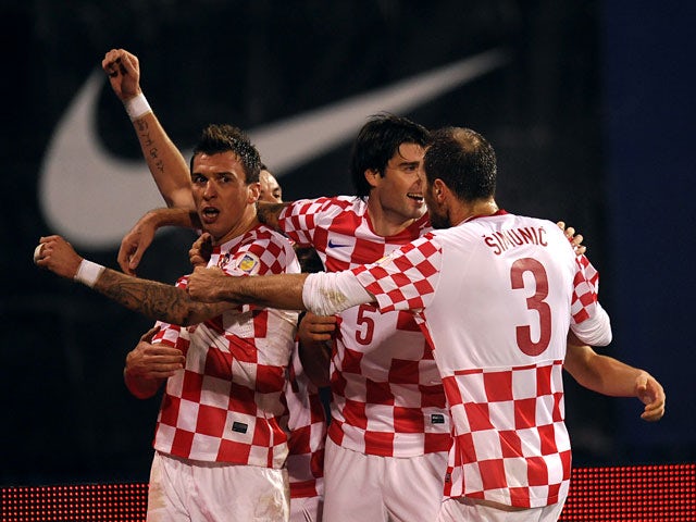 Croatia's Mario Mandzukic celebrates with teammates after scoring the opening goal against Iceland during their World Cup play off match on November 19, 2013