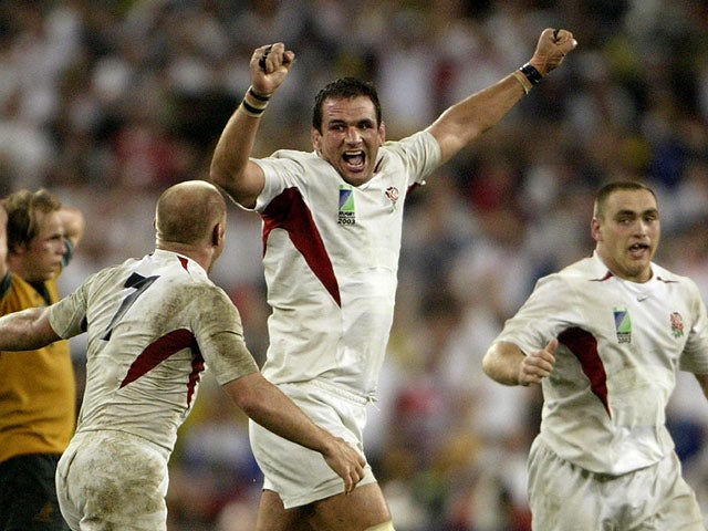 England captain Martin Johnson celebrates winning the World Cup with teammates at the end of the match against Australia on November 22, 2003