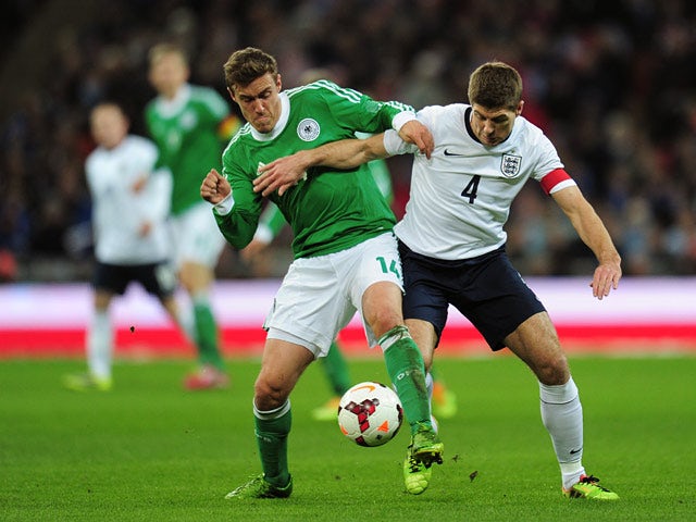 Germany's Max Kruse and England's Steven Gerrard battle for the ball during their international friendly match on November 19, 2013