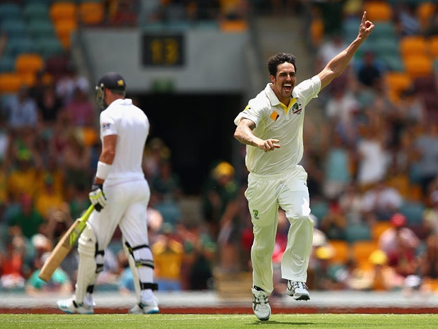Australia 's Mitchell Johnson celebrates after dismissing England's Kevin Pietersen during day four of the First Ashes Test match on November 24, 2013