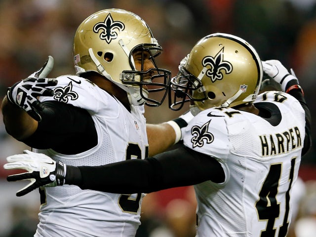 Defensive end Cameron Jordan #94 celebrates with strong safety Roman Harper #41 of the New Orleans Saints after sacking quarterback Matt Ryan #2 of the Atlanta Falcons during a game at the Georgia Dome on November 21, 2013
