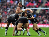 England's Sam Burgess is tackled by New Zealand's Elijah Taylor, Ben Matulino, Bryson Goodwin and Simon Mannering during the 2013 Rugby League World Cup semi-final match between England and New Zealand at Wembley Stadium in London, England on November 23,