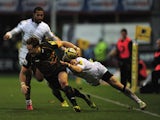 James Wilson of Northampton Saints is tackled by Alex Tait of Newcastle Falcons during the Aviva Premiership match between Northampton Saints and Newcastle Falcons at Franklin's Gardens on November 23, 2013