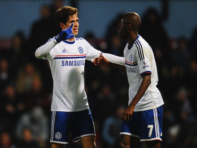 Oscar of Chelsea celebrates scoring the second goal with Ramires during the Barclays Premier League match against West Ham United on November 23, 2013