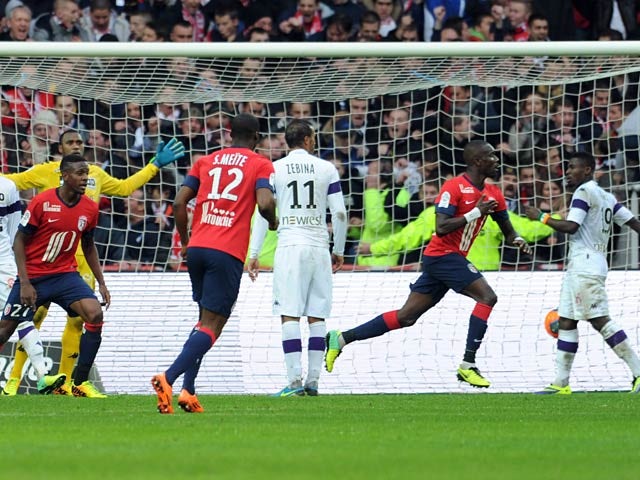 Lille's Pape Souare celebrates after scoring the opening goal against Toulouse on November 24, 2013