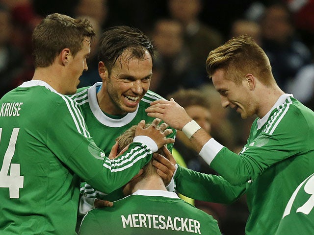 Germany's Per Mertesacker is congratulated by teammates after scoring the opening goal against England during their international friendly match on November 19, 2013