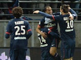 Paris Saint-Germain's Brazilian forward Lucas Moura is congratulated by his teammates after scoring a goal during the French Football match Reims vs Paris Saint-Germain, on November 23, 2013