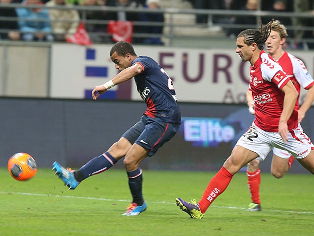 Paris Saint-Germain's Brazilian forward Lucas Moura strikes to score a goal during the French Football match Reims vs Paris Saint-Germain, on November 23, 2013 