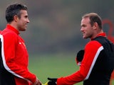 Wayne Rooney and Robin van Persie of Manchester United talk during a training session ahead of their Champions League Group A match against Shakhtar Donetsk at their Carrington Training Complex on October 01, 2013
