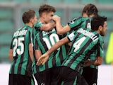 Sassuolo's Simone Zaza is congratulated by teammates after scoring his team's opening goal against Atalanta on November 24, 2013