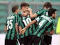 Sassuolo's Simone Zaza is congratulated by teammates after scoring his team's opening goal against Atalanta on November 24, 2013