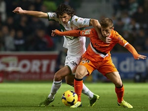 Stevanovic of Elche competes for the ball with Fede of Valencia during the La Liga match between Elche FC and Valencia CF at Manuel Martinez Valero on November 24, 2013