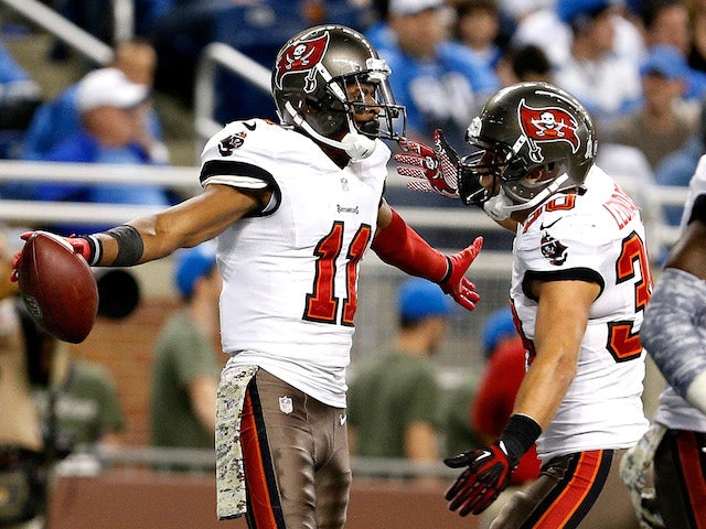 Tiquan Underwood of the Tampa Bay Buccaneers celebrates a touchdown catch in the fourth quarter with Brian Leonard at Ford Field on November 24, 2013
