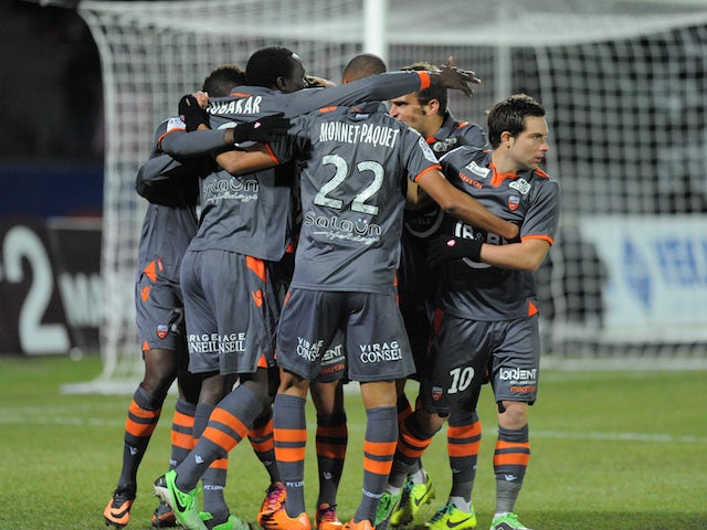 Lorient forward Vincent Aboubakar is congratulated by his teammates after scoring against Evian on November 23, 2013