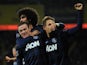 Man United's Wayne Rooney is congratulated by teammates after scoring the opening goal against Cardiff on November 24, 2013