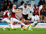 Adel Taarabt of Fulham is tracked by Mark Noble, James Collins, Guy Demel and James Tomkins of West Ham United during the Barclays Premier League match on November 30, 2013