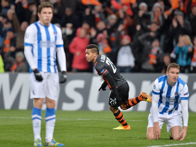 Shakhtar's Alex Teixeira celebrates after scoring his team's second goal against Real Sociedad during their Champions League group match on November 27, 2013