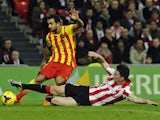 Athletic Bilbao's French defender Aymeric Laporte tackles Barcelona's defender Martin Montoya during the Spanish league football match Athletic Club Bilbao vs FC Barcelona at the San Mames stadium in Bilbao on December 1, 2013