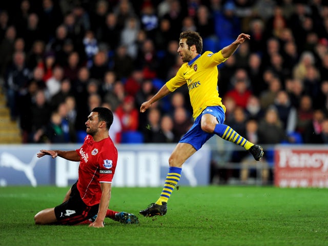 athieu Flamini of Arsenal beats Steven Caulker of Cardiff City as he scores their second goal during the Barclays Premier League match between Cardiff City and Arsenal at Cardiff City Stadium on November 30, 2013