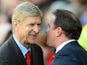 Arsenal's French manager Arsene Wenger chats with Cardiff City manager Malky Mackay before the English Premier League football match between Cardiff City and Arsenal at The Cardiff City stadium in Cardiff, south Wales on November 30, 2013