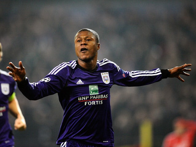 Anderlecht's Chancel Mbemba celebrates after scoring the opening goal against Benfica during their Champions League group match on November 27, 2013