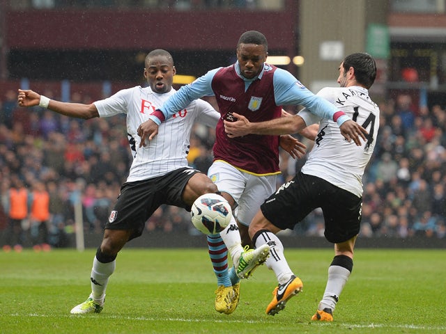 Charles N'Zogbia of Aston Villa is challenged by Giorgos Karagounis and Eyong Enoh of Fulham during the Barclays Premier League match between Aston Villa and Fulham at Villa Park on April 13, 2013