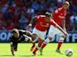 Shaun Maloney of Wigan Athletic and Chris Dagnall of Barnsley challenge for the ball during the Sky Bet Championship match between Barnsley and Wigan Athletic at Oakwell on August 03, 2013