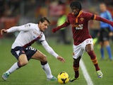 Daniele Dessena of Cagliari competes for the ball with Gervinho of AS Roma during the Serie A match between AS Roma and Cagliari Calcio at Stadio Olimpico on November 25, 2013
