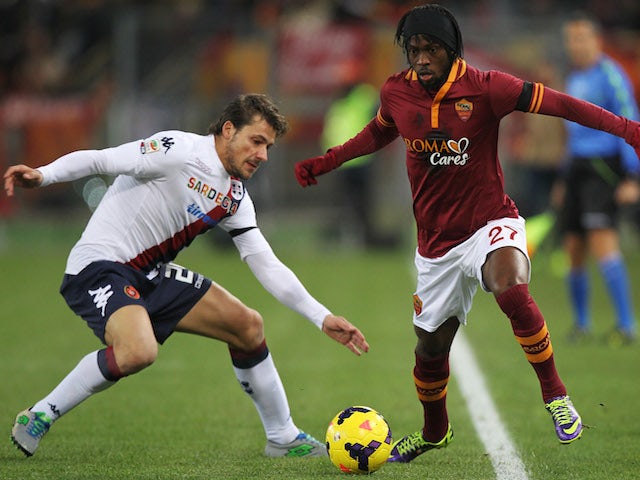 Daniele Dessena of Cagliari competes for the ball with Gervinho of AS Roma during the Serie A match between AS Roma and Cagliari Calcio at Stadio Olimpico on November 25, 2013