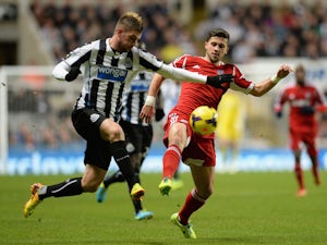 Davide Santon of Newcastle United competes with Shane Long of West Bromwich Albion during the Barclays Premier League match on November 30, 2013