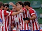 Atletico Madrid's midfielder Koke celebrates with his teammates after scoring during the Spanish league football match Elche vs Club Atletico de Madrid at the Manuel Martinez Valero Stadium in Elche on November 30, 2013