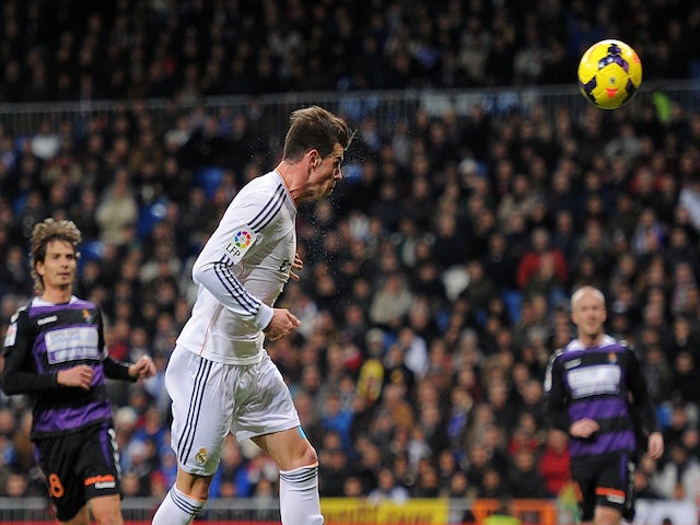 Gareth Bale of Real Madrid CF scores Real's opening goal during the La Liga match between Real Madrid CF and Real Valladolid CF at Santiago Bernabeu stadium on November 30, 2013