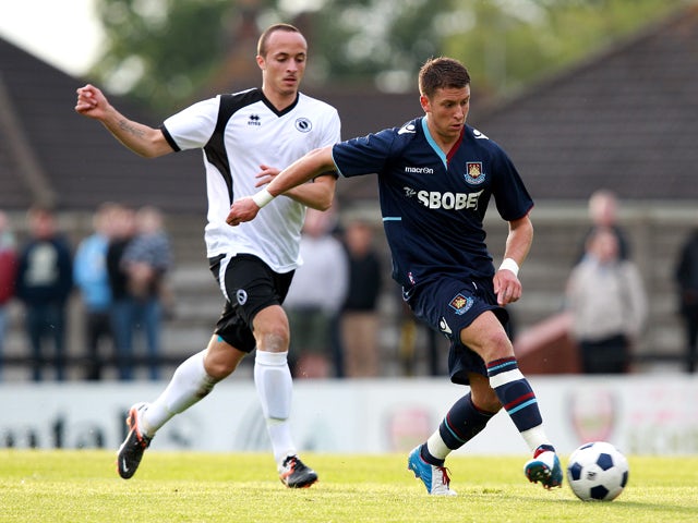 George Moncur of West Ham controls the ball from Elliot Buchanan of Boreham Wood during a Pre-Season Friendly match between Boreham Wood FC and West Ham United at Meadow Park on July 10, 2012