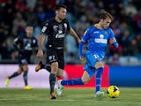 Rafael Lopez of Getafe CF competes for the ball with David Barral Torres of Levante UD during the La Liga match between Getafe CF and Levante UD at Coliseum Alfonso Perez on November 29, 2013