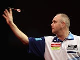 Ian White of Great Britain throws against Robert Thornton of Great Britain during day three of the 2012 Ladbrokes.com World Darts Championship at Alexandra Palace on December 17, 2011