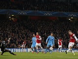 Arsenal's English midfielder Jack Wilshere scores his second goal during the UEFA Champions League group F football match between Arsenal and Olympique de Marseille at the Emirates Stadium on November 26, 2013