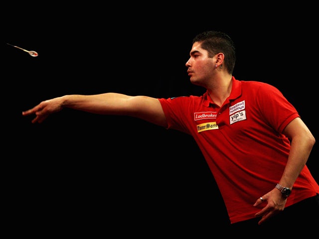 Jelle Klaasen of Holland collects his darts in his match against James Wade of England during day nine of the 2012 Ladbrokes.com World Darts Championship at Alexandra Palace on December 23, 2011