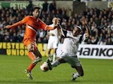 Swansea's Chico Flores and Valencia's Jonas battle for the ball during their Europa League group match on November 28, 2013