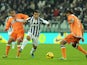 Carlos Tevez of Juventus is challenged by Allan Marques of Udinese Calcio during the Serie A match between Juventus and Udinese Calcio at Juventus Arena on December 1, 2013